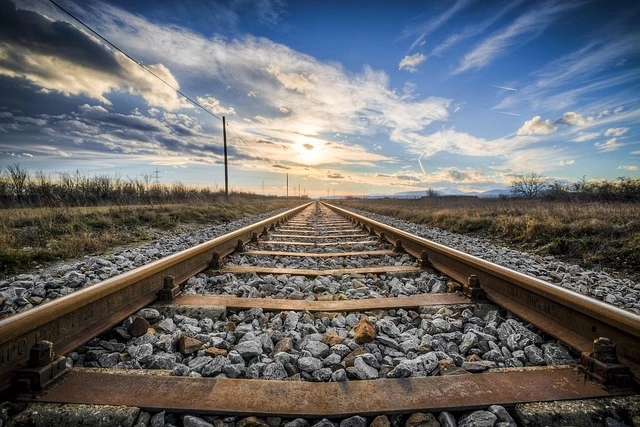 A rail station and tracks under dim evening light illustrating vulnerability in transit environments