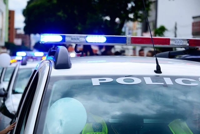 A police patrol vehicle with emergency lights in an urban street environment